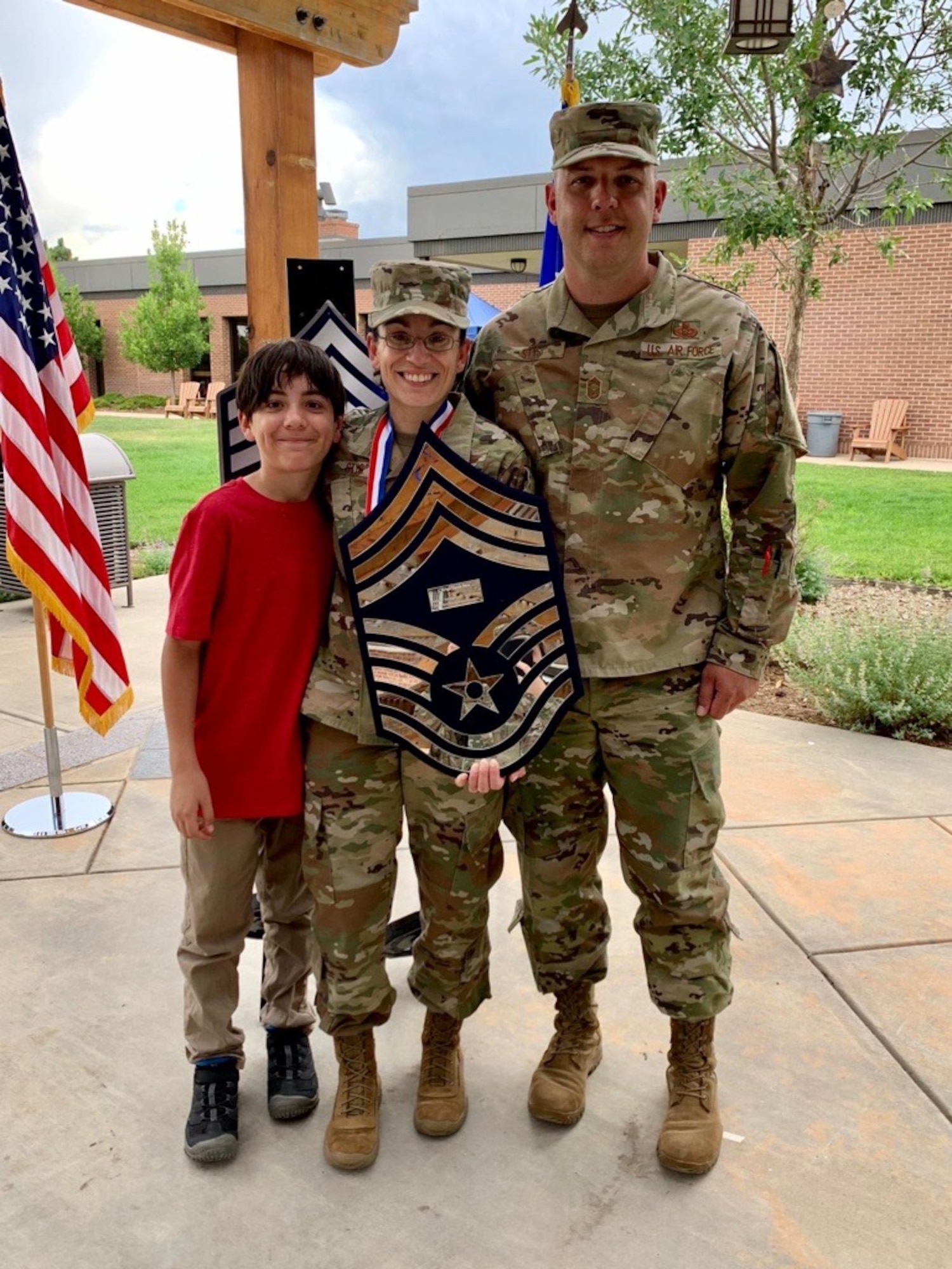 From left, Brandon Stys, 11, chief master sergeant promotee, Senior Master Sgt. Taryn Stys, 4th Space Control Squadron superintendent, and Chief Master Sgt. Zack Stys, Headquarters United States Space Force enlisted cyber functional manager, smile for a photo during the chief master sergeant recognition ceremony at Peterson Air Force Base, Colorado, July 22, 2020. Stys sewed on the rank of chief master sergeant Oct. 1, 2020, almost one month after transitioning to the USSF. (courtesy photo)