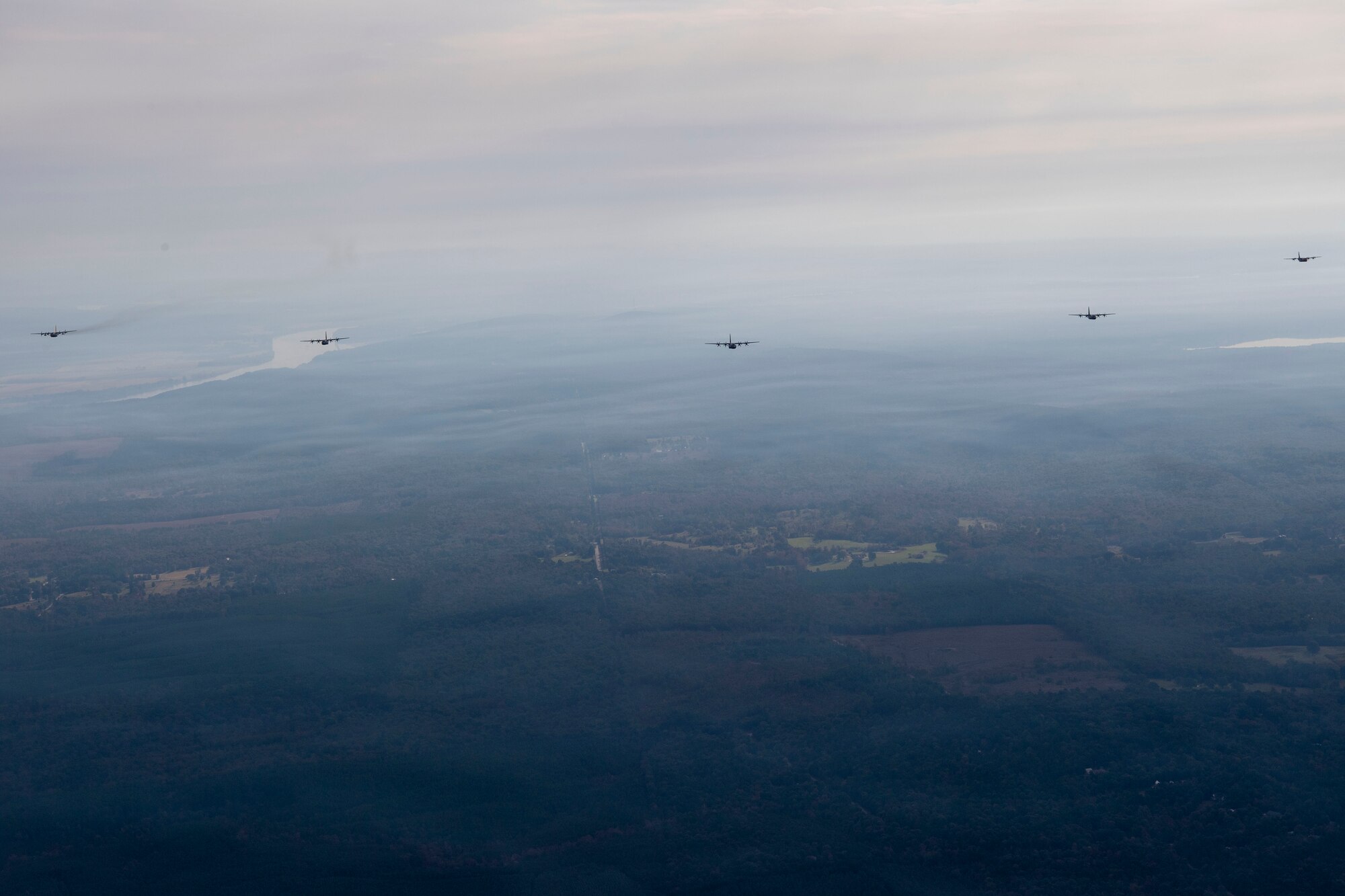 Planes flying in formation over fields