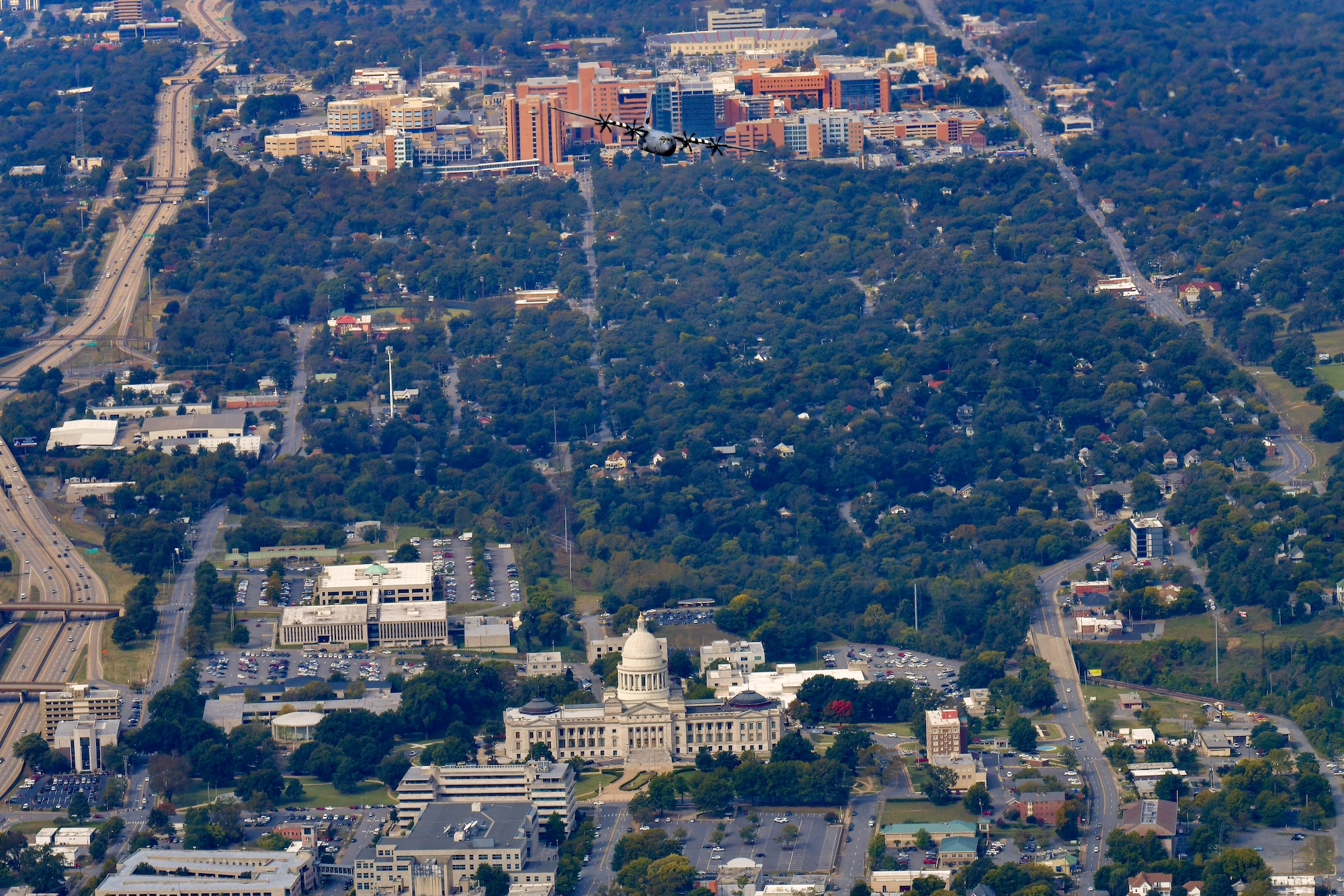 Plane flying over building