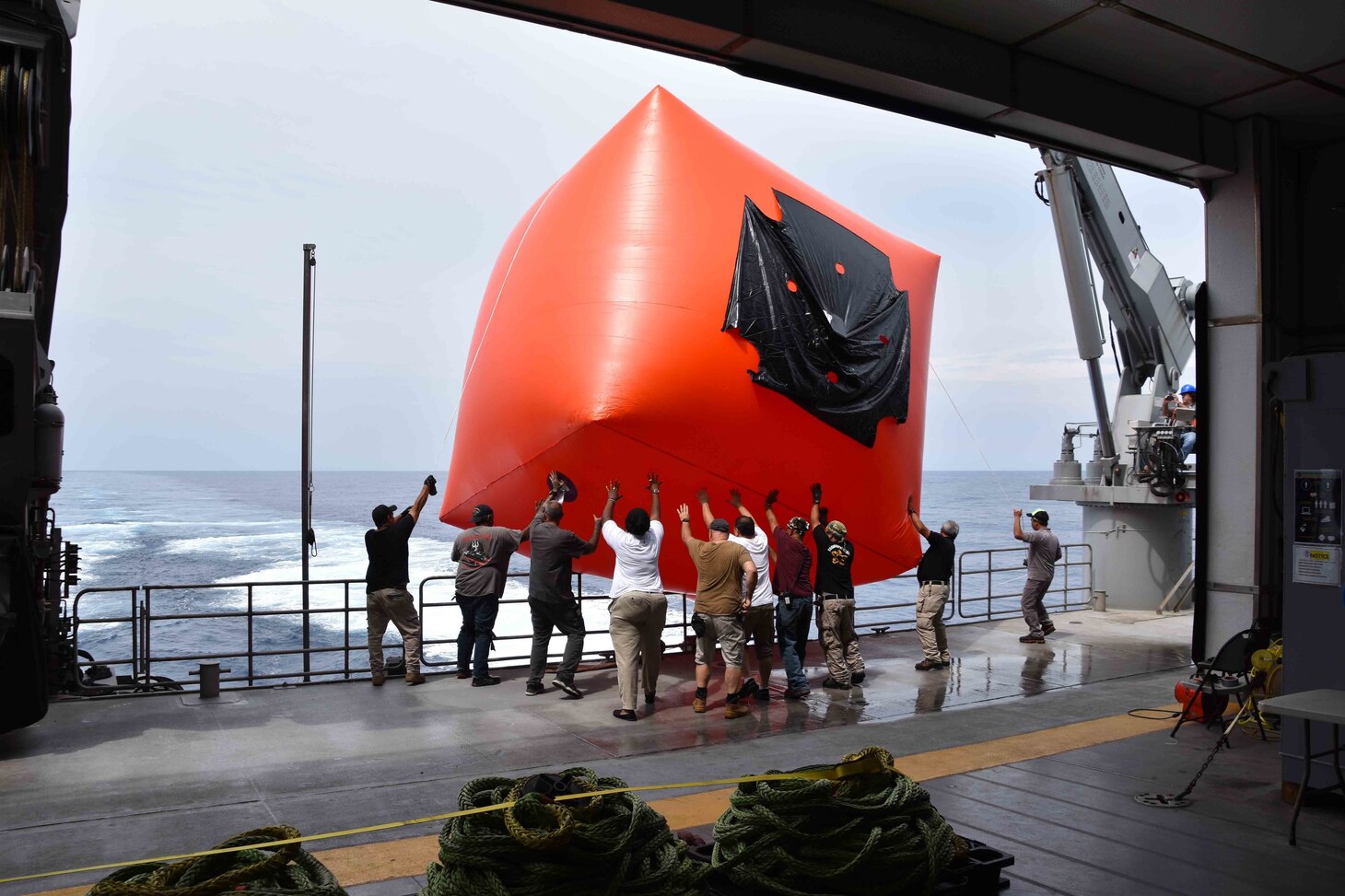 SOUTH CHINA SEA (Oct. 6, 2020) Crew members aboard USNS Millinocket (T-EPF 3) releases a “killer tomato” target before a gunnery exercise with Royal Brunei Navy and Air Force during Cooperation Afloat Readiness and Training (CARAT) Brunei. This year marks the 26th iteration of CARAT, a multinational exercise designed to enhance U.S. and partner navies' abilities to operate together in response to traditional and non-traditional maritime security challenges in the Indo-Pacific region. (U.S. Navy photo by Lt. Alexander Laabs)