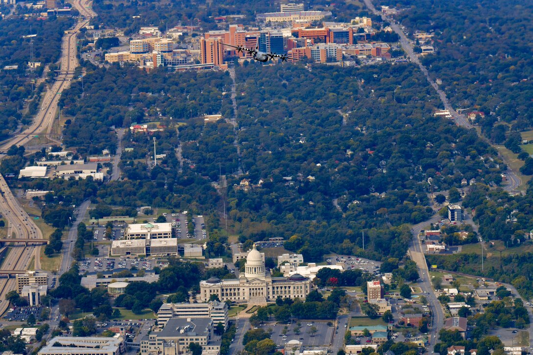 Plane flying over building