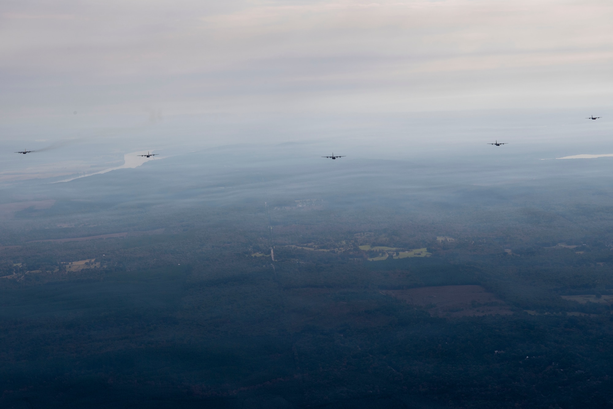 Planes flying in formation over fields