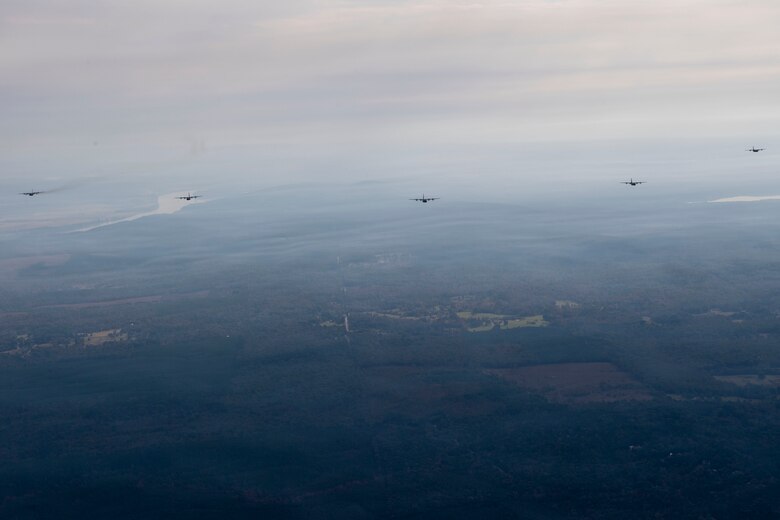 Planes flying in formation over fields