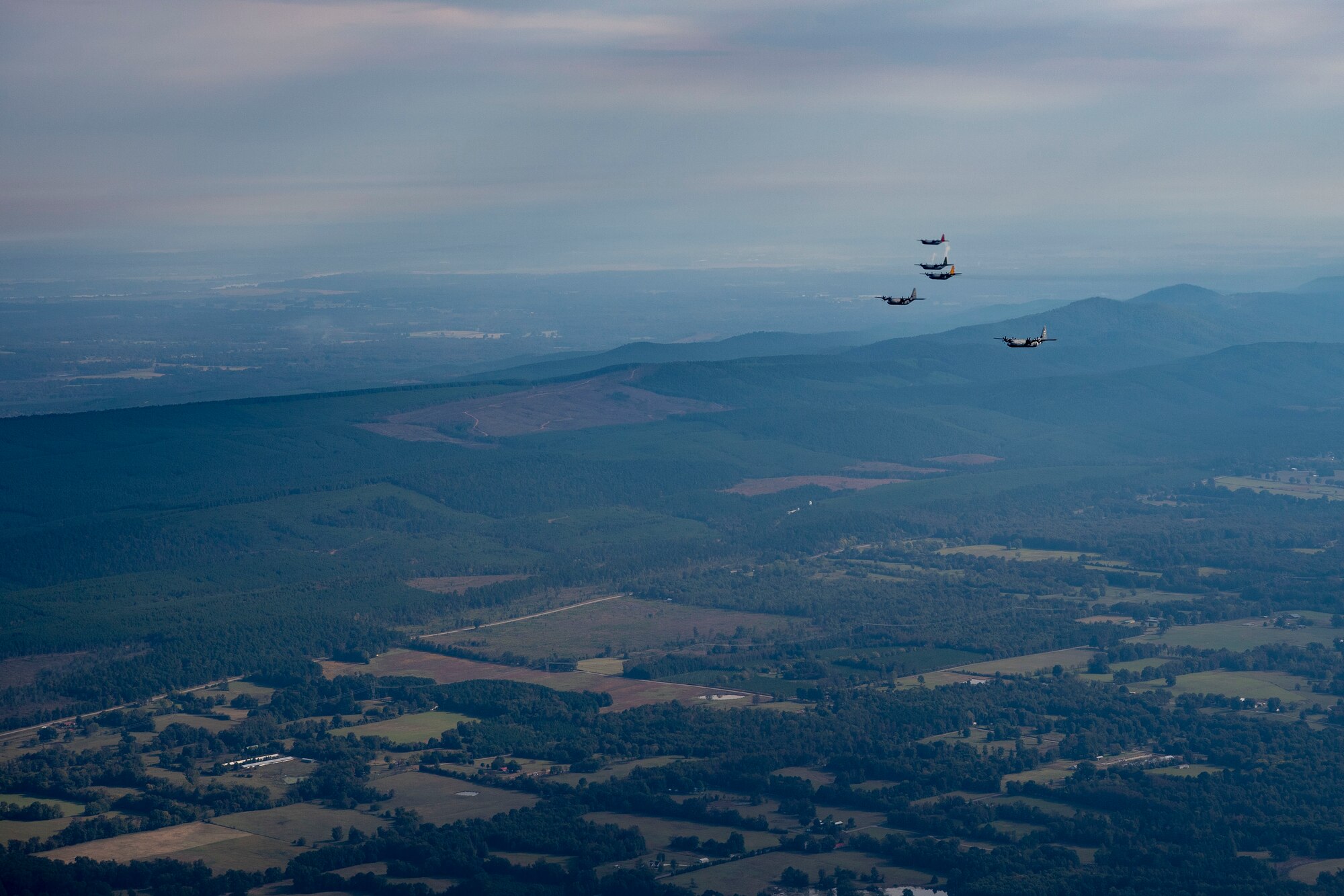 planes flying in formation over fields