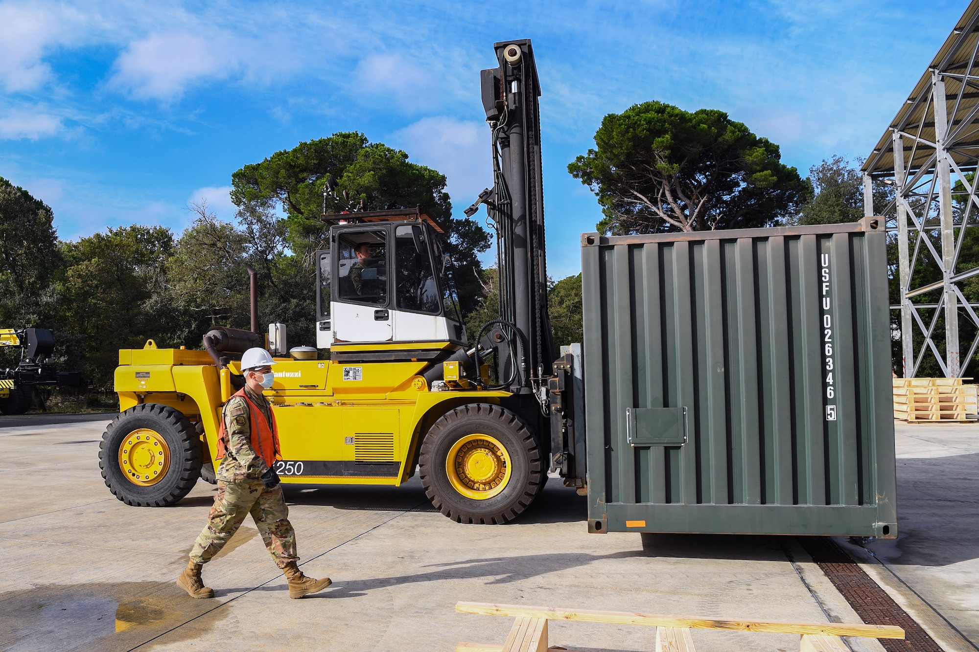 Airmen with the 731st Munitions squadron operate a forklift carrying an intermodal shipping container (ISO) during an exercise at Camp Darby, Italy, Oct. 7, 2020. The ISOs contained munitions that were prepared for shipment during the exercise Waking Giant. (U.S. Air Force photo by Airman 1st Class Thomas S. Keisler IV)