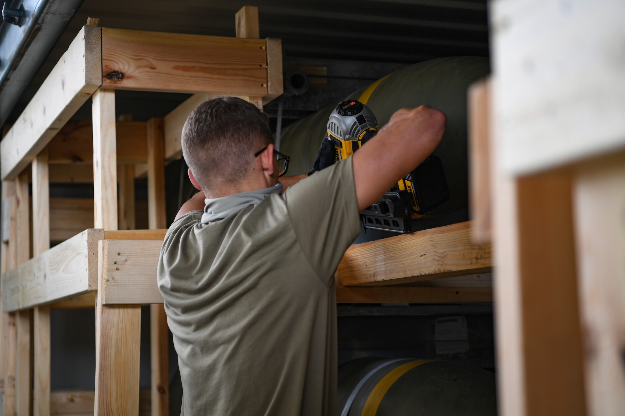 An Airman with the 731st Munitions Squadron secures bracing inside an intermodal shipping container (ISO) during an exercise at Camp Darby, Italy, Oct. 7, 2020. The bracing was made to secure the munitions inside the ISOs throughout the shipping process. (U.S. Air Force photo by Airman 1st Class Thomas S. Keisler IV)