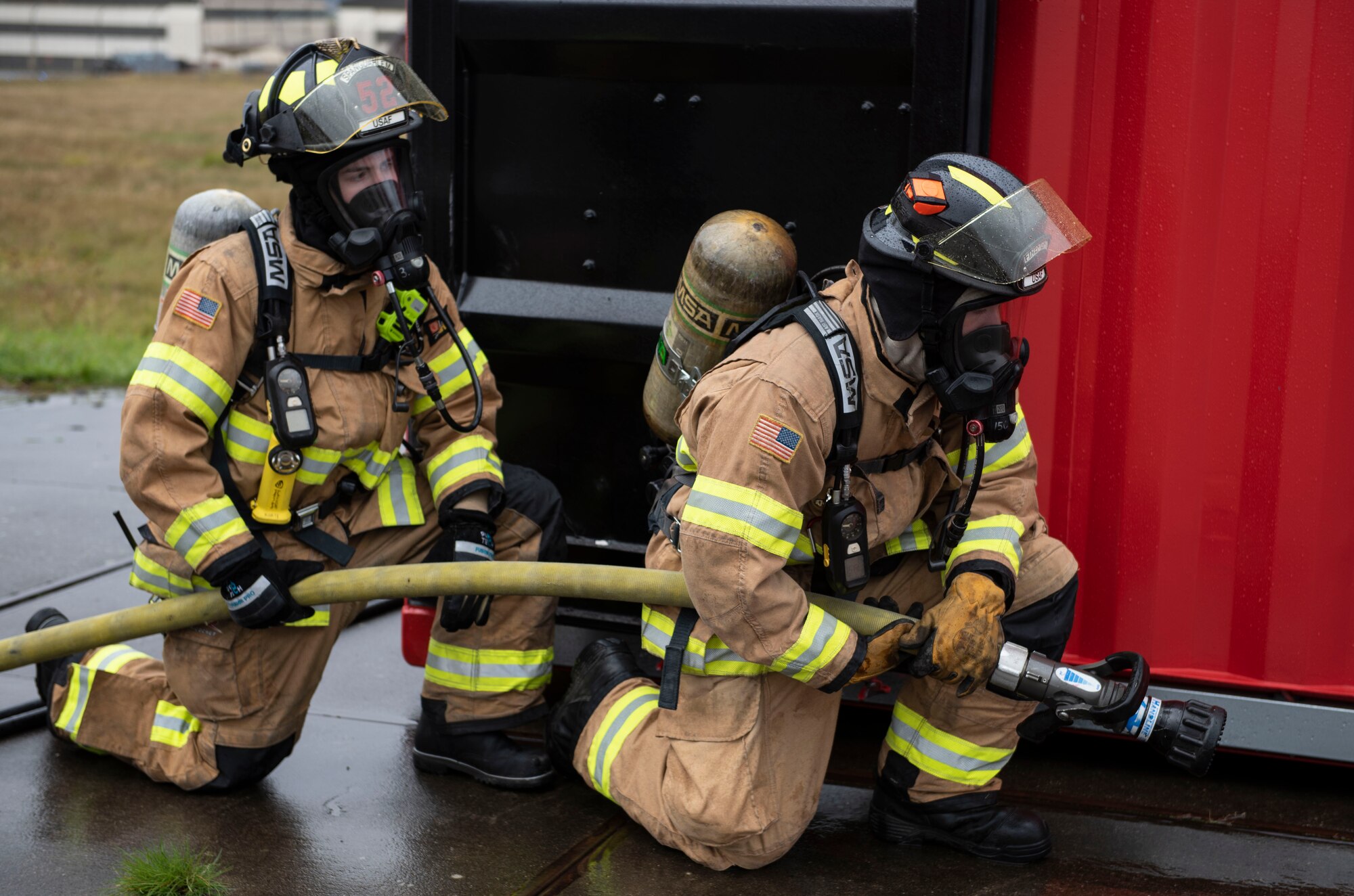 U.S. Air Force Airmen 1st Class Andre Korte, left, and Nathaniel Corder, 52nd Civil Engineer Squadron Fire and Emergency Services firefighters, prepare for a building fire simulation, Oct. 5, 2020, at Spangdahlem Air Base, Germany. Air force firefighters use simulators to ensure mission readiness and capabilities for any situation at all times. (U.S. Air Force photo by Senior Airman Melody W. Howley)