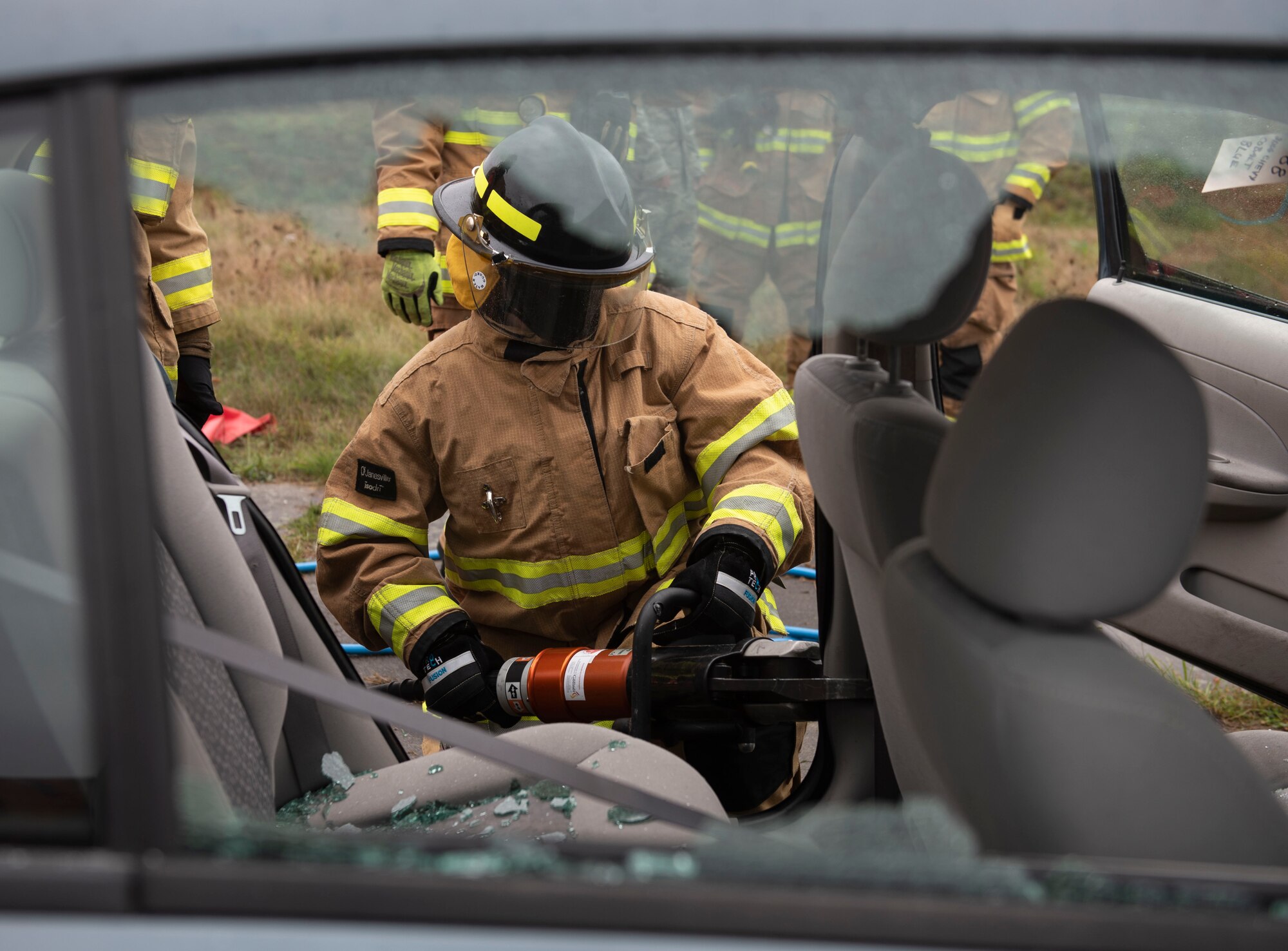 52nd Fighter Wing leadership participate in a vehicle extrication simulation for Fire Prevention Week, Oct. 5, 2020, at Spangdahlem Air Base, Germany. Wing leadership had the opportunity to use tools and simulate rescuing a victim from a vehicle. (U.S. Air Force photo by Senior Airman Melody W. Howley)