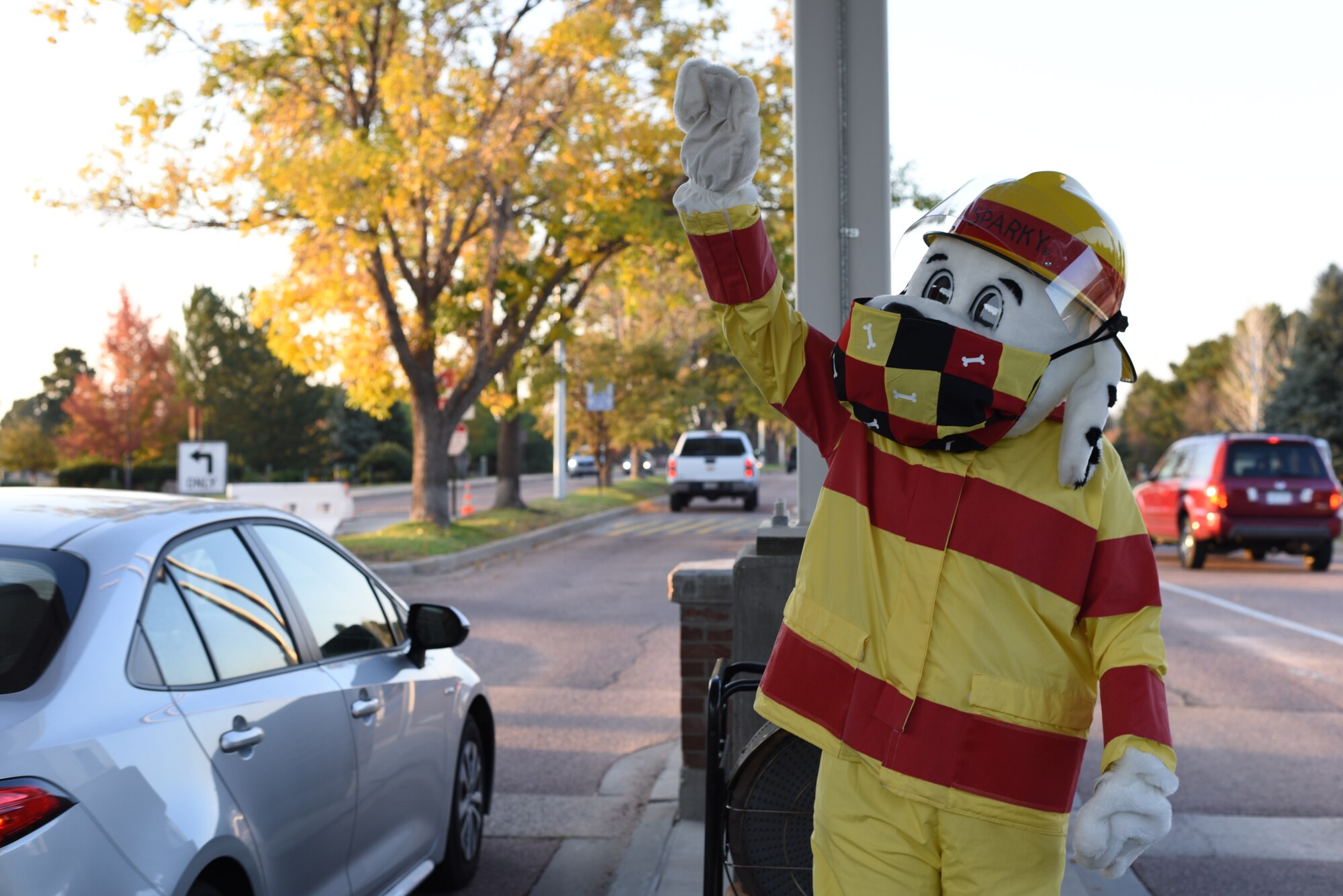 Picture of Sparky the Fire Dog waving at cars passing through the gates