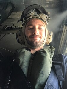 Thomas Bruno, an electrical engineer from Naval Surface Warfare Center, Carderock Division, in a helicopter as he is transferred from USS Antietam (CG 54) to USS Barry (DDG 52)