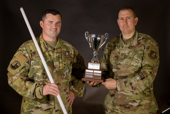 Two Airmen Pose with the Osan Energy Cup