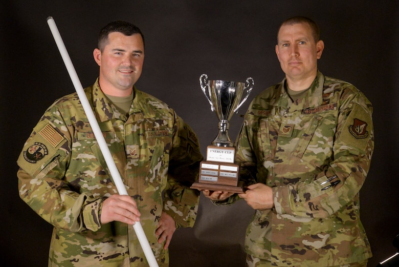 Two Airmen Pose with the Osan Energy Cup