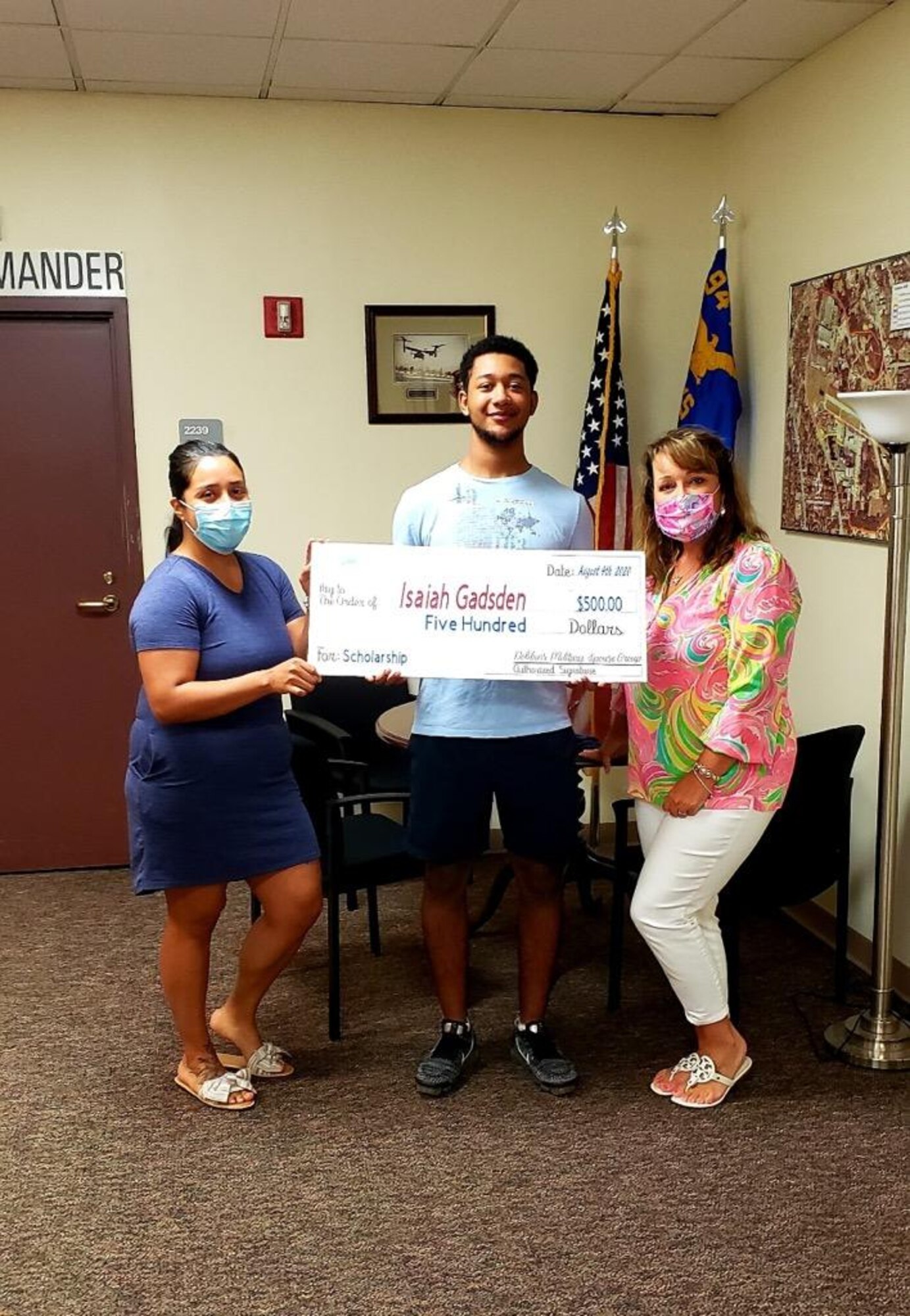 The Dobbins Military Spouse Group presents a check to Specialist Isaiah Gadsden, an Army National Guard infantryman with B Co 1/121, at Dobbins Air Reserve Base, Ga. Aug. 4, 2020. Gadsden was awarded $500 for the Dobbins Military Spouse Group Dependent Scholarship. (Courtesy photo)