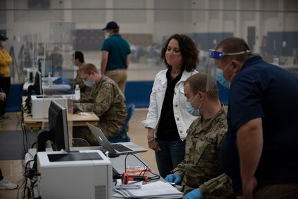 Spc. Kelton Miller, of the West Virginia National Guard’s Task Force Chemical, Biological, Radiological and Nuclear (CBRN) Response Enterprise (CRE) (TF-CRE), helps roll out a new COVID-19 data entry computer application, West Virginia University Student Recreation Center, Sept. 30, 2020. TF-CRE members have assisted state health departments with COVID-19 testing since March.