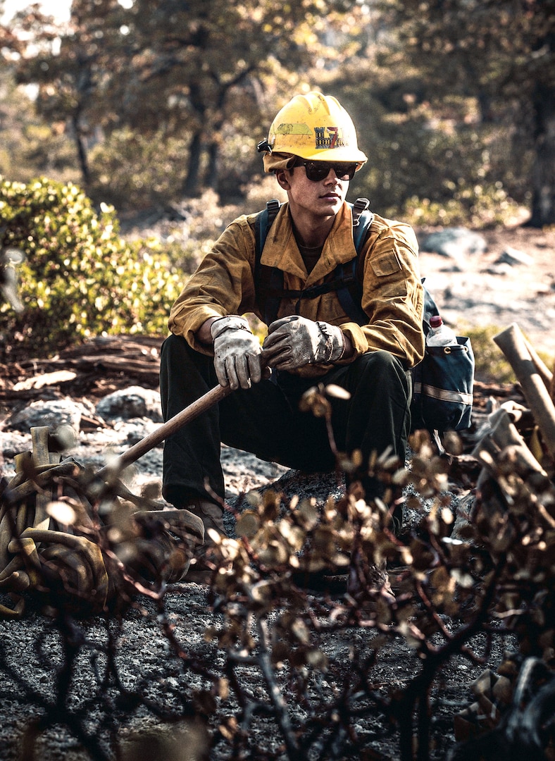 A U.S. Marine assigned to the 7th Engineer Support Battalion, 1st Marine Logistics Group, takes a much-needed break from conducting wildland firefighting operations with National Interagency Fire Center personnel near the Sierra National Forest Oct. 5.