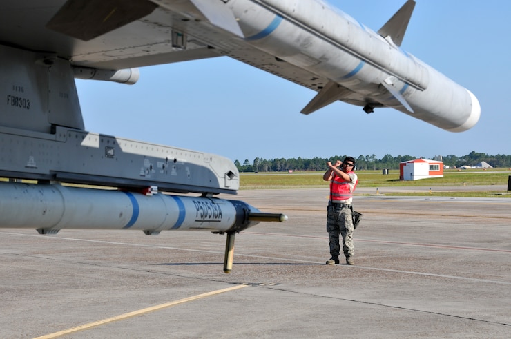 U.S. Air Force Staff Sgt. Daniel Umana, weapons armament systems specialist with the 177th Fighter Wing, marshals an F-16 Fighting Falcon prior to a training mission on May 4, 2015 at Tyndall Air Force Base, Fla. Fighter pilots, maintainers and support staff from the N.J. Air National Guard unit deployed to Tyndall for Combat Archer training at the 53D Weapons Evaluations Group, testing weapons systems, from start to finish, in the air-to-air realm. (U.S. Air National Guard photo by Master Sgt. Andrew J. Moseley/Released)