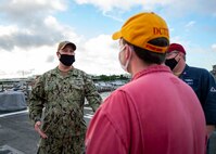 Senior Chief Damage Controlman William Merchen, an inspector with Afloat Training Group Atlantic (ATG), speaks with members of the damage control training team aboard the USS Cole (DDG 67).