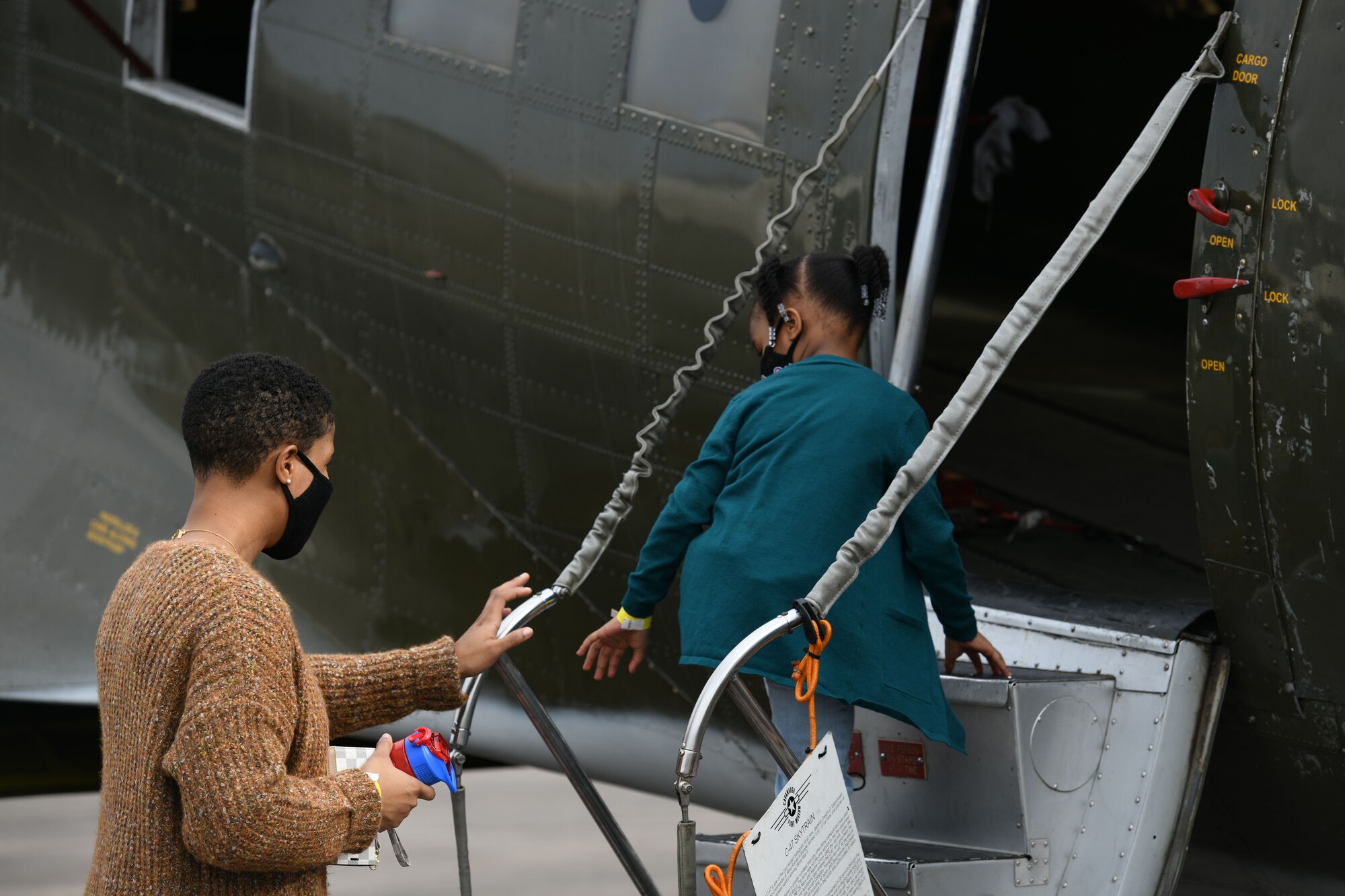 A woman and her child enter historical Aircraft