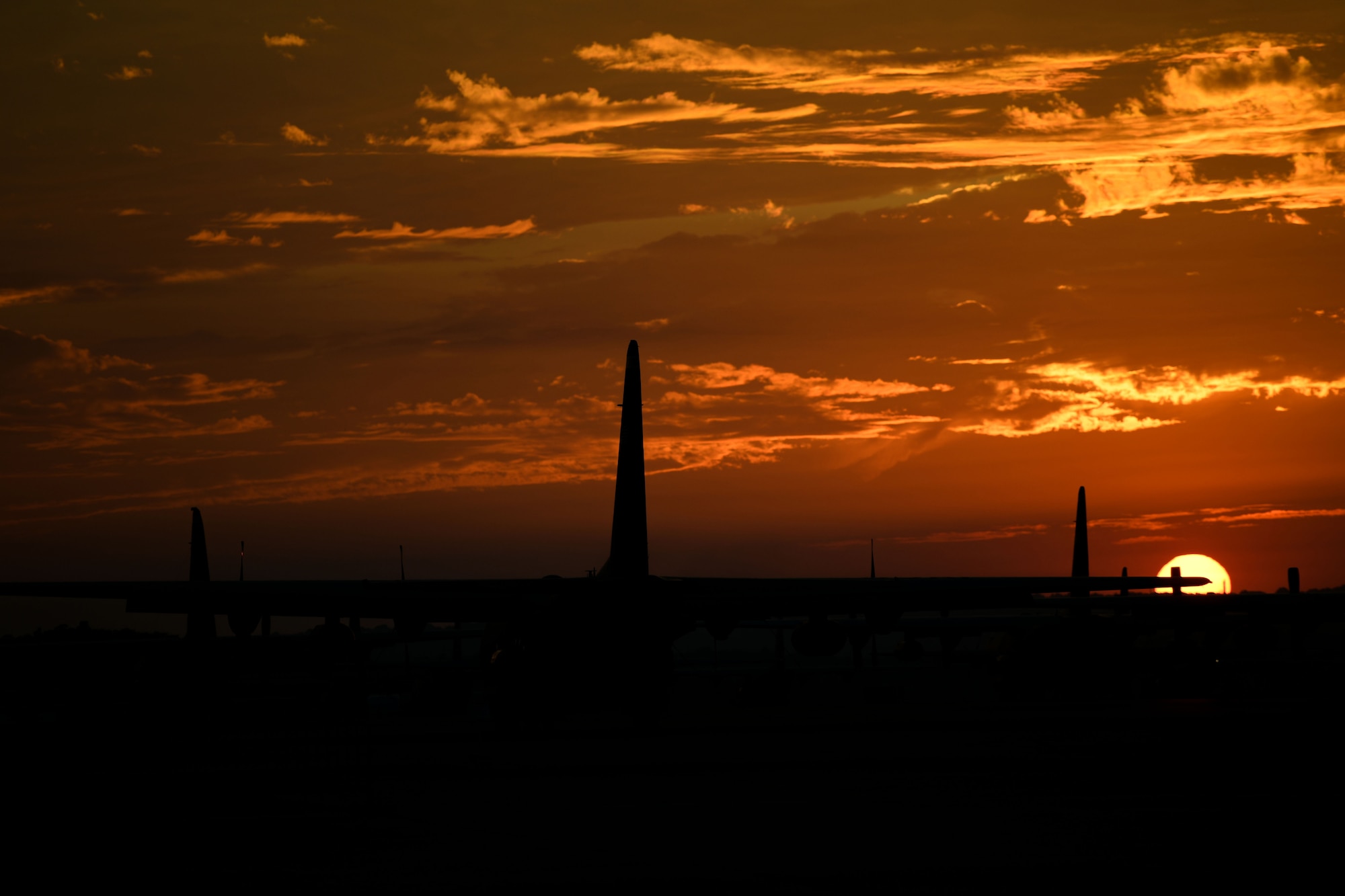 Planes on runway at sunset