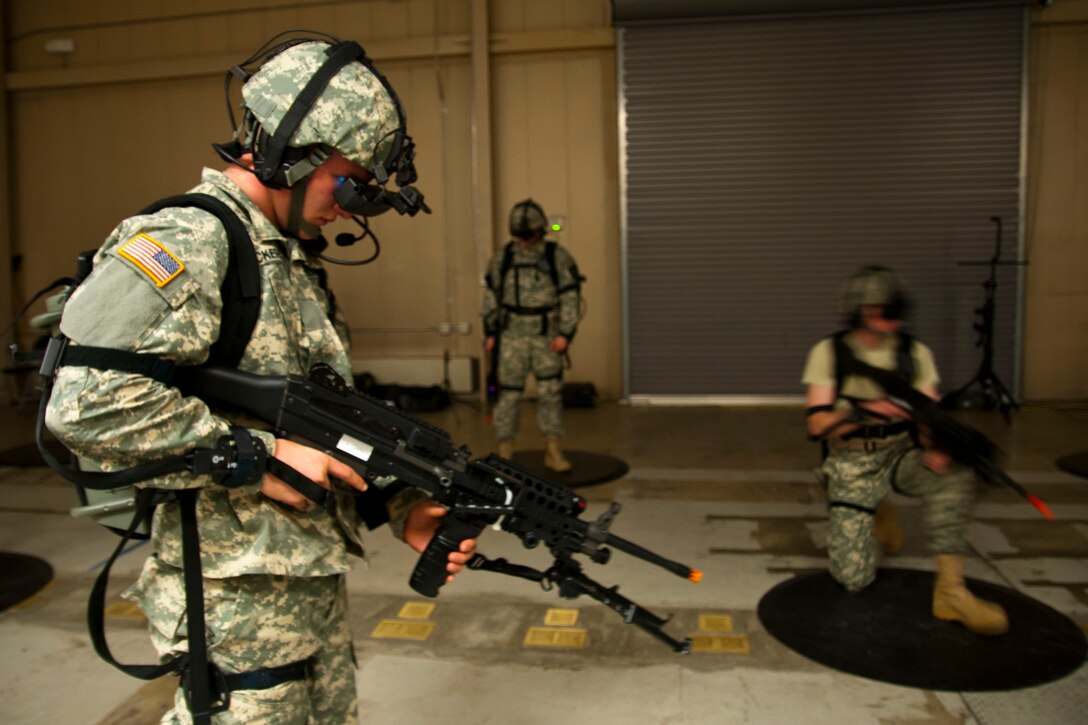 Three service members are outfitted with virtual reality technology.