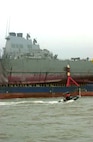 The USS Cole (DDG 67) aboard the Blue Marlin was escorted into a U.S. port for the first time since the attack.