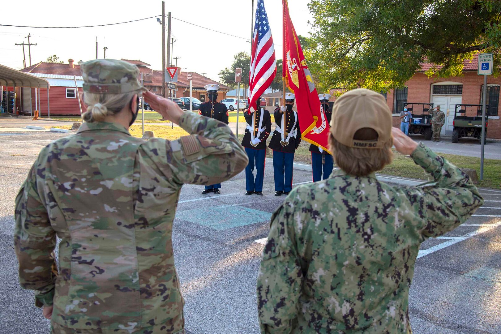 Brig. Gen. Caroline Miller (left), JBSA and 502nd Air Base Wing commander, and Rear Adm. Cynthia Kuehner (right), Navy Medicine Education, Training & Logistics Command commander, render salutes at the start of the National Night Out ceremony at JBSA-Fort Sam Houston Oct. 6.