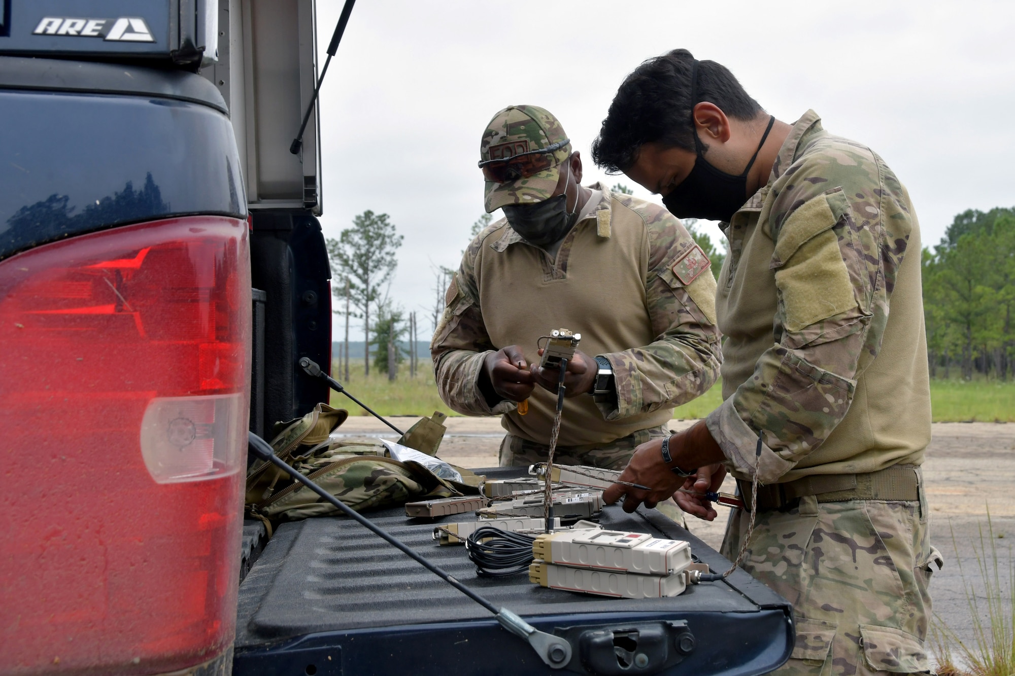 Chief Master Sgt. Antoine Thomas, 94th EOD Flight chief, and Staff Sgt. Juan Ortiz, 94th EOD Flight technician, prepare remote firing devices at Fort Stewart, Georgia, Sept. 16, 2020. Throughout the exercise, members went through numerous tasks such as working with electric demolition procedures, non-electric demolition procedures, demolition shape charges and cratering charges. (U.S. Air Force photo by Airman 1st Class Kendra A. Ransum)