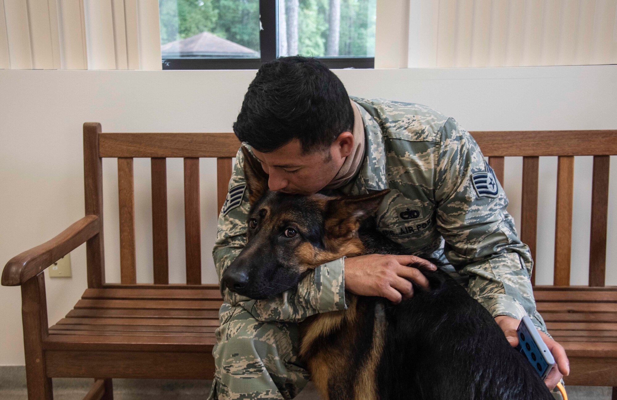 Staff Sgt. Christopher Burgoa, 336th Fighter Squadron avionics technician craftsman, sits in the waiting room of the base veterinary clinic with his dog, Lucifer, at Seymour Johnson Air Force Base, North Carolina, Sept. 29, 2020. Burgoa took Lucifer into the vet to have his back leg examined, after noticing he had been walking with a limp. (U.S. Air Force photo by Senior Airman Kylee Gardner)