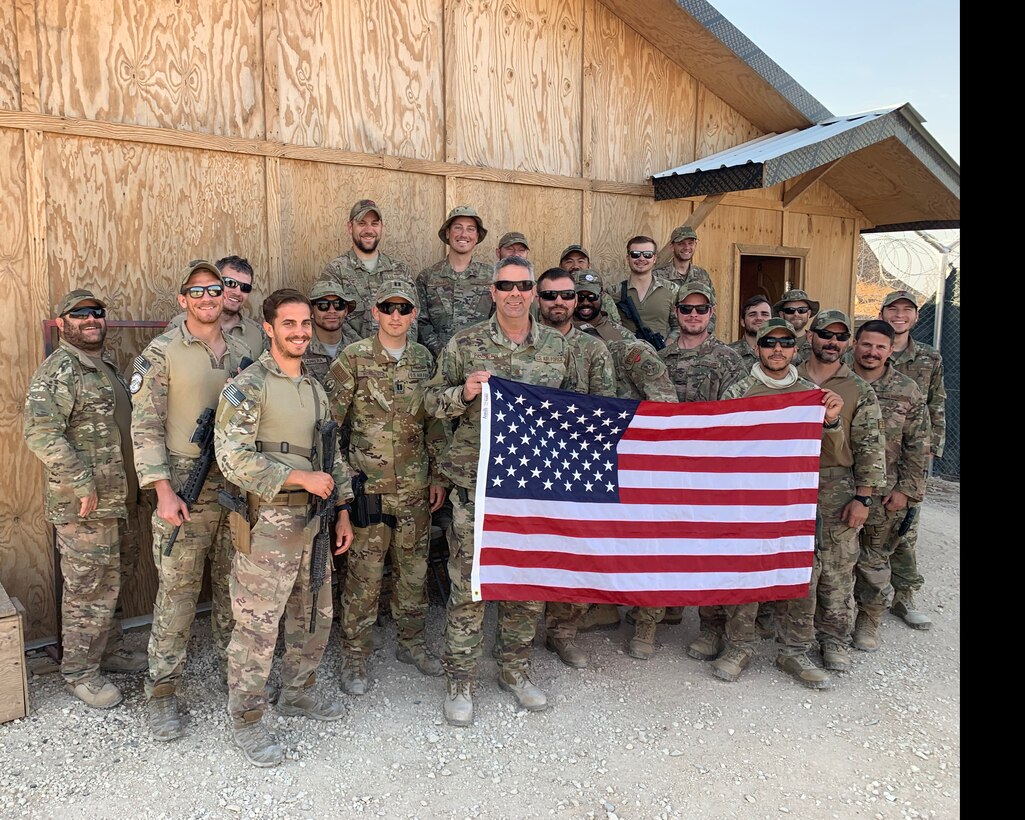 Maj. Russel Pangburn, (center) 759th Logistics Readiness Flight, poses for a photo with his team while on deployment to Syria. (Courtesy Photo)