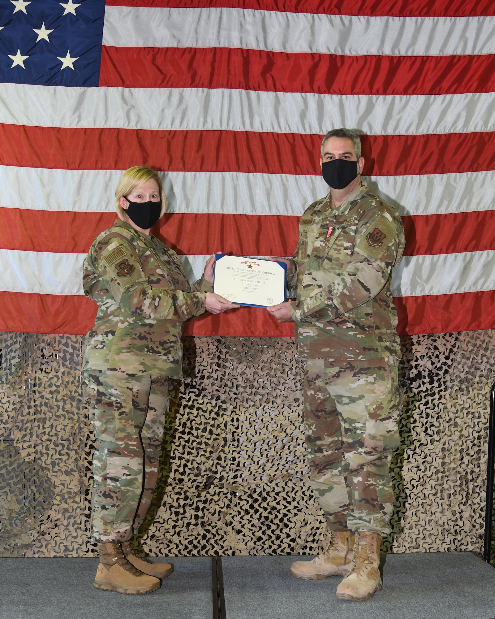 Col. Ann Brown, 459th Mission Support Group commander, poses for a photo with Maj. Russell Pangburn, 759th Logistics Readiness Flight, Oct. 4th 2020, at Joint Base Andrews, MD. Pangburn was awarded the Bronze Star for his meritorious achievement while deployed to Iraq and Syria in support of Operation Inherent Resolve from Sept. 2019 to April 2020. (U.S. Air Force Photo/Staff Sgt. Cierra Presentado)