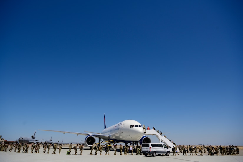 Airmen boarding an airplane.