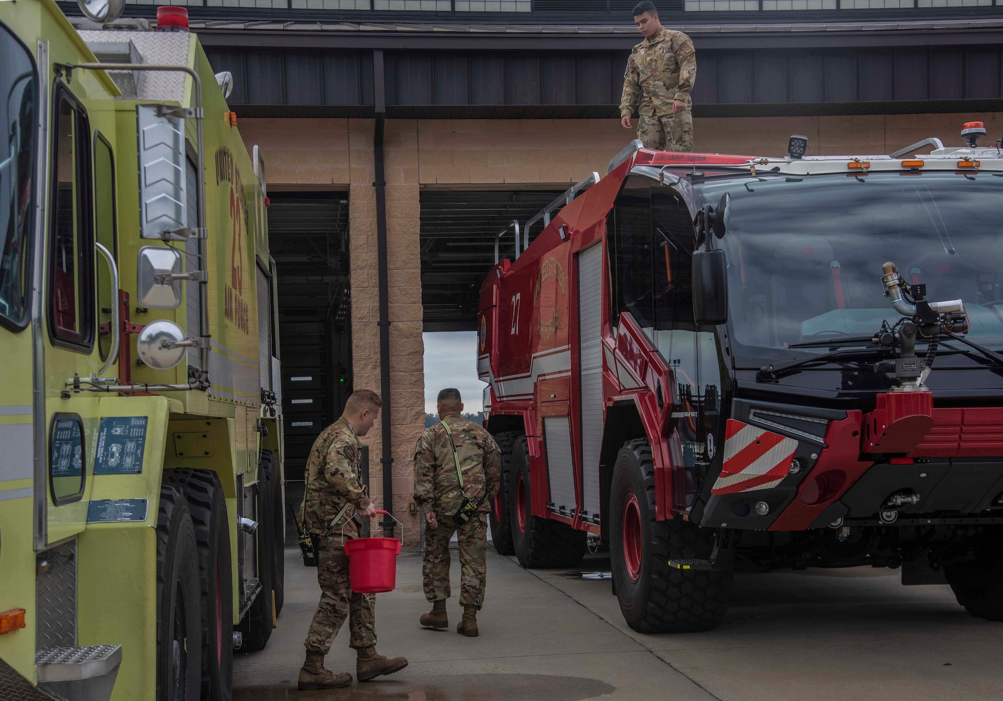 Airmen from the 4th Civil Engineer Squadron fire department exchange water from an old fire truck into the new fire truck at Seymour Johnson Air Force Base, N.C., Oct. 9, 2020. During the ceremonial exchange of fire trucks, the water leftover in the old truck is exchanged into the new one. (U.S. Air Force photo by Senior Airman Kylee Gardner)