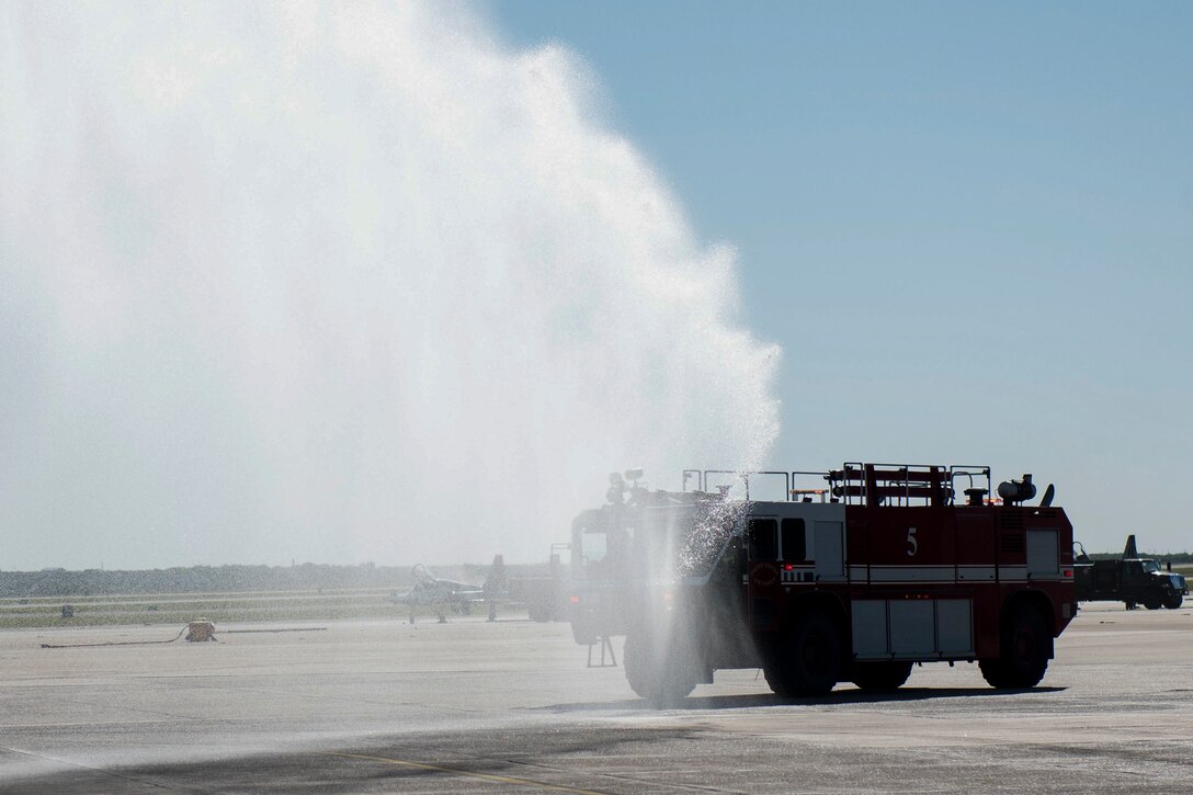 Team XL's fire team rush to an exercise held at the flightline where an aircraft is on fire and a pilot is unconscious, Sept. 30, 2020, at Laughlin Air Force Base, Texas. This is the first exercise the team has been able to do since the COVID pandemic started. (U.S. Air Force photo by Airman 1st Class David Phaff)