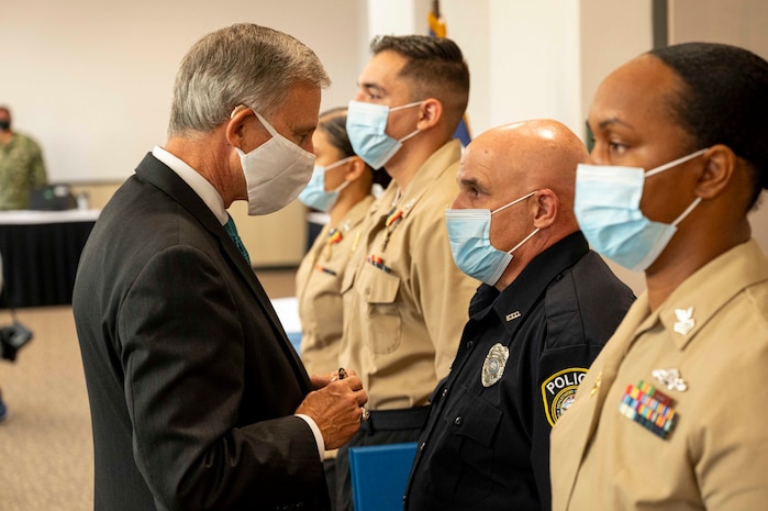 Acting Under Secretary of the Navy Gregory J. Slavonic awards officer Stuart Levitt with the Distinguished Civilian Medal for Valor during an award ceremony at Naval Air Station Corpus Christi.