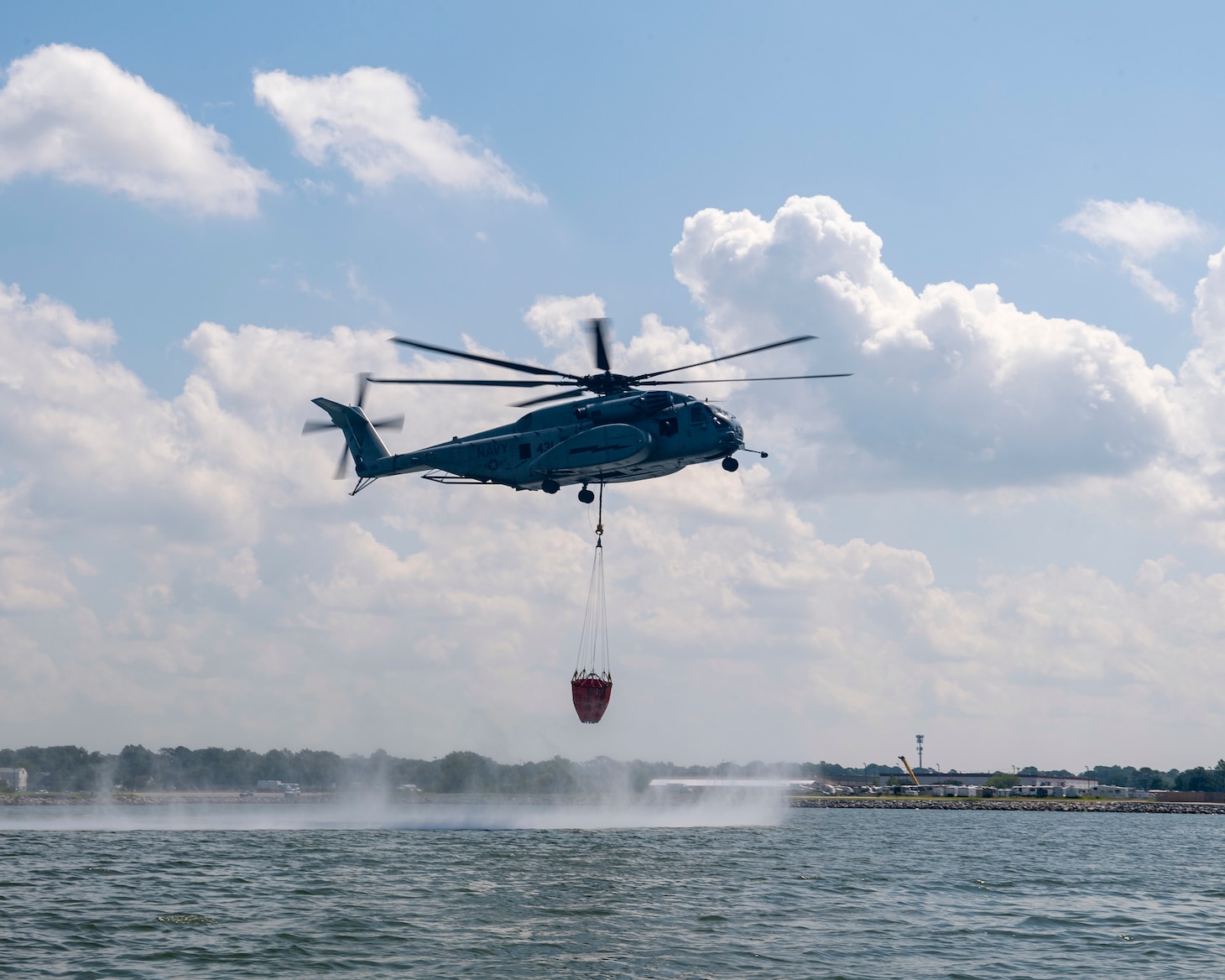 An MH-53E Sea Dragon helicopter, assigned to the "Sea Dragons" of Helicopter Mine Countermeasures Squadron (HM) 12, performs aerial firefighting training exercises using a 1,300 gallon Bambi Bucket Sept. 3, 2020.
