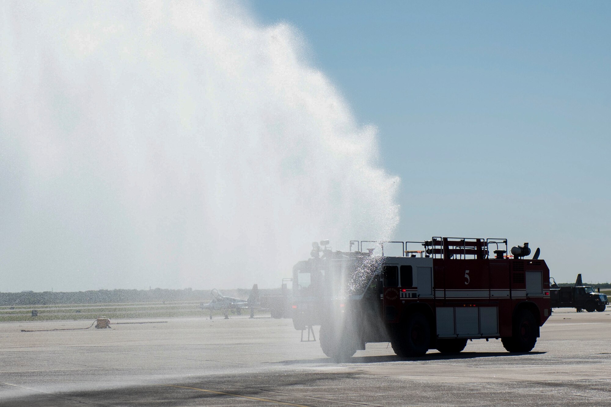 The team XL fire team rush to an exercise held at the flightline where an aircraft is on fire and a pilot is unconscious, Sept. 30, 2020, at Laughlin Air Force Base, Texas. This is the first exercise the team has been able to do since the COVID pandemic started. (U.S. Air Force photo by Airman 1st Class David Phaff)