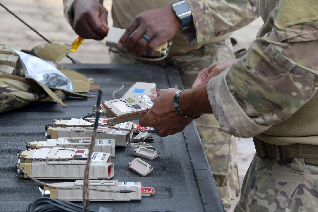 Chief Master Sgt. Antoine Thomas, 94th EOD Flight chief, and Staff Sgt. Juan Ortiz, 94th EOD Flight technician, prepare remote firing devices at Fort Stewart, Georgia, Sept. 16, 2020. Throughout the exercise, members went through numerous tasks such as working with electric demolition procedures, non-electric demolition procedures, demolition shape charges and cratering charges. (U.S. Air Force photo by Airman 1st Class Kendra A. Ransum)