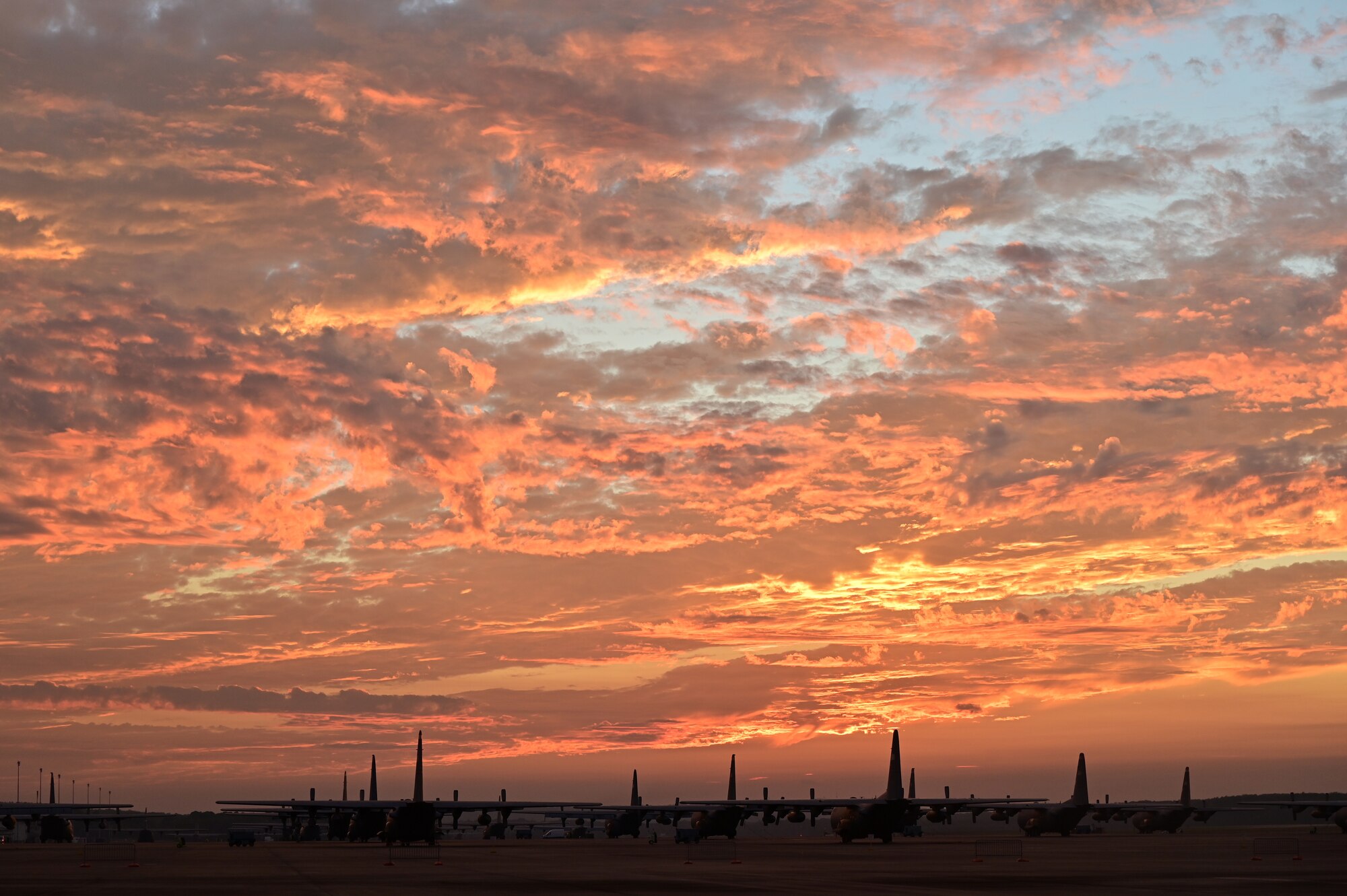 Planes sit on flight line at sunset
