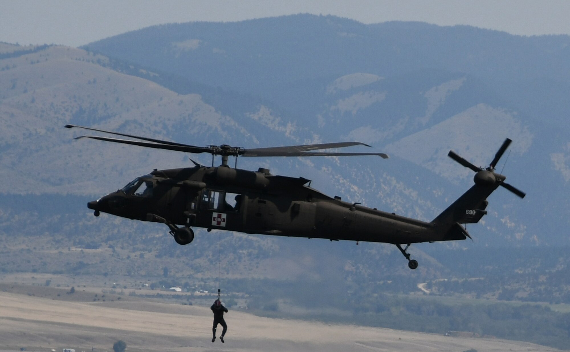 A UH-60 Black Hawk helicopter crew conducts hoist training to maintain proficiency in July 2020.