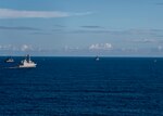 An Italian NH 90 helicopter assigned to the Italian Navy frigate ITS Federico Martinengo (F 596) flies over participants in the French-led exercise Grand African NEMO in the Gulf of Guinea, Oct. 8, 2020.