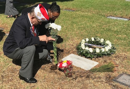 Theresa Snell and a Veterans of Foreign Wars officer lay flowers at the grave of Seaman Lakiba Nicole Palmer to remember the San Diego native who lost her life onboard USS Cole (DDG 67) during the terrorist attack on the ship on Oct. 12, 2000 in Aden, Yemen.