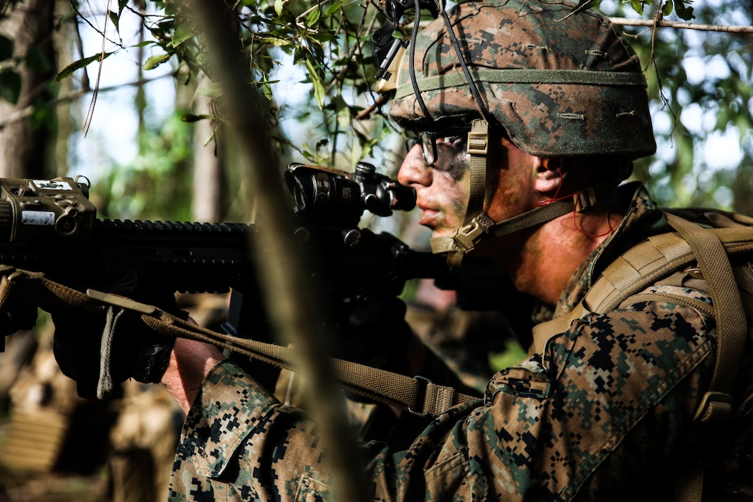 Private First Class Seth Nans posts security during an airfield assault and seizure simulation at Marine Corps Outlying Landing Field, Camp Davis, NC, June 9, 2020. The simulation was a part of a Marine Corps Air-Ground Task Force exercise with the 24th Marine Expeditionary Unit. The exercise is designed to increase the MEU’s proficiency and enhance their capabilities as a MAGTF. Nans is an infantry automatic rifle gunner with 1st Battalion, 8th Marine Regiment. (U.S. Marine Corps photo by Cpl. Margaret Gale)