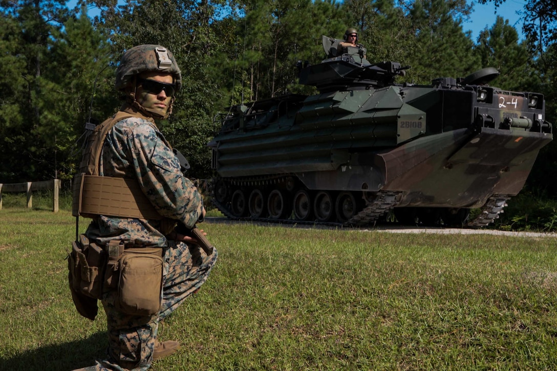 U.S. Marine Corps Lance Cpl. Alexander Dawson, a mortarman with 1st Battalion 8th Marines, provides security next to an amphibious assault vehicle at the area of operation at Camp Lejeune, N.C., Sept. 22, 2020. The purpose of the exercise was to promote familiarization with ship to shore procedures and raid tactics for pre-deployment readiness with the 24th Marine Expeditionary Unit. (U.S. Marine Corps photo by Lance Cpl. Davis Harris)