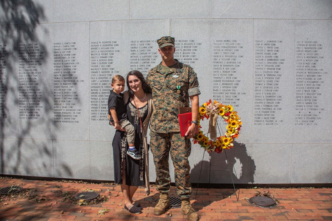 U.S. Navy Corpsman HM1 Michael D. Bryson, poses for a photo with his wife Summer and his son Benjamin at an award ceremony at Camp Lejeune, N.C., September 22, 2020. Bryson received the Chief Hospital Corpsman George William “Doc” Piercy award, which recognizes one Navy corpsmen who has earned the Fleet Marine Force (FMF) badge for contributing to the combat readiness of any air or ground element in the Marine Corps. Bryson also received a Navy Commendation Medal for his outstanding service and accomplishments while serving as a corpsman for 1st Battalion 8th Marine Regiment. (U.S. Marine Corps photo by Lance Cpl. Nicholas Guevara)