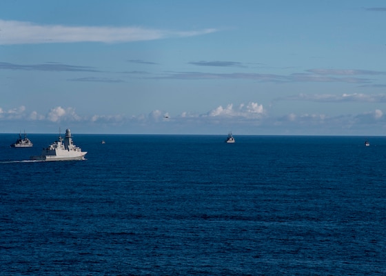 An Italian NH 90 helicopter assigned to the Italian Navy frigate ITS Federico Martinengo (F 596) flies over participants in the French-led exercise Grand African NEMO in the Gulf of Guinea, Oct. 8, 2020.