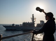 201008-N-NC885-1058 GULF OF OMAN (Oct. 8, 2020) - Yeoman 2nd Class Wanda Taylor, assigned to the guided-missile destroyer USS Sterett (DDG 104), waves to Sailors aboard the Royal Navy frigate HMS Montrose (F236) as Sterett assumes duties in support of Operation Sentinel in the Gulf of Oman, Oct. 8. Sterett is part of the Nimitz Carrier Strike Group, deployed to the U.S. 5th Fleet area of operations, currently supporting Operation Sentinel to ensure maritime security and stability in the critical waterways of the Central region.
(U.S. Navy photo by Mass Communication Specialist Seaman Drace Wilson)