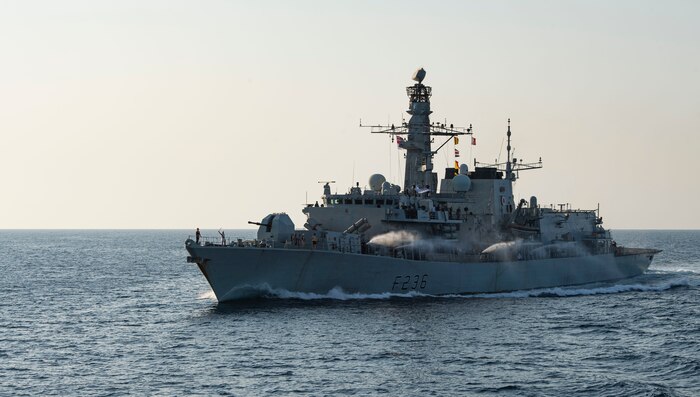 201008-N-NC885-1120 GULF OF OMAN (Oct. 8, 2020) - The Royal Navy frigate HMS Montrose (F236) discharges fire hoses as part of a time honored tradition during a passing exercise with the guided-missile destroyer USS Sterett (DDG 104) in the Gulf of Oman, Oct. 8. Sterett is part of the Nimitz Carrier Strike Group, deployed to the U.S. 5th Fleet area of operations, currently supporting Operation Sentinel to ensure maritime security and stability in the critical waterways of the Central region.	
(U.S. Navy photo by Mass Communication Specialist Seaman Drace Wilson)