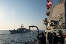 201008-N-NC885-1134 GULF OF OMAN (Oct. 8, 2020) - The Royal Navy frigate HMS Montrose (F236) discharges fire hoses as part of a time honored tradition while Sailors assigned to the guided-missile destroyer USS Sterett (DDG 104) wave during a passing exercise in the Gulf of Oman, Oct. 8. Sterett is part of the Nimitz Carrier Strike Group, deployed to the U.S. 5th Fleet area of operations, currently supporting Operation Sentinel to ensure maritime security and stability in the critical waterways of the Central region.
(U.S. Navy photo by Mass Communication Specialist Seaman Drace Wilson)
