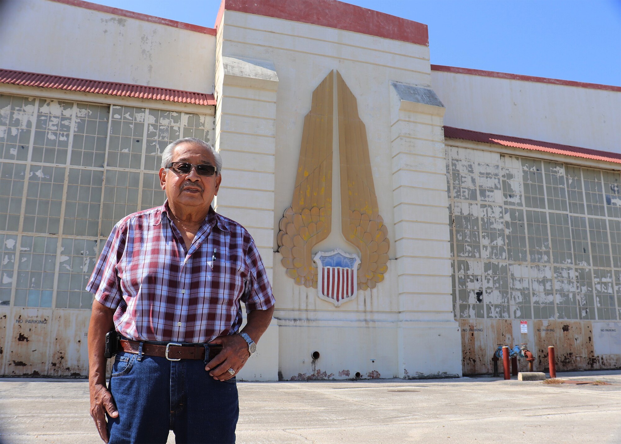 Felix R. Gonzalez, grandfather of Tech. Sgt. Christine R. Narro, 433rd Aerospace Medicine Squadron, optometry technician, visits an old hanger Oct. 10, 2020 on what is now called Kelly Field that once was used for aircraft in depot status at Kelly Air Force Base. Gonzalez recalls his work on the Veterans Monument on Kelly Air Force Base, that was dedicated in May of 1992 to honor service members who served in Operations Desert Shield and Desert Storm. The Monument has since been moved from its original location until a new location is found. (U.S. Air Force photo by Tech. Sgt. Iram Carmona)