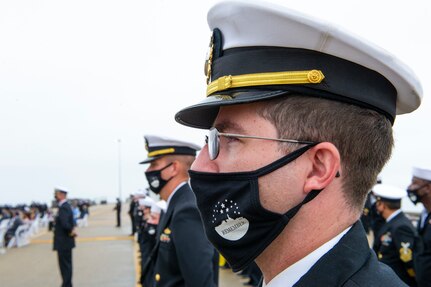 Sailors assigned to the Arleigh Burke-class guided missile destroyer USS Cole (DDG 67) stand at attention during the 20th Anniversary memorial ceremony onboard Naval Station Norfolk.